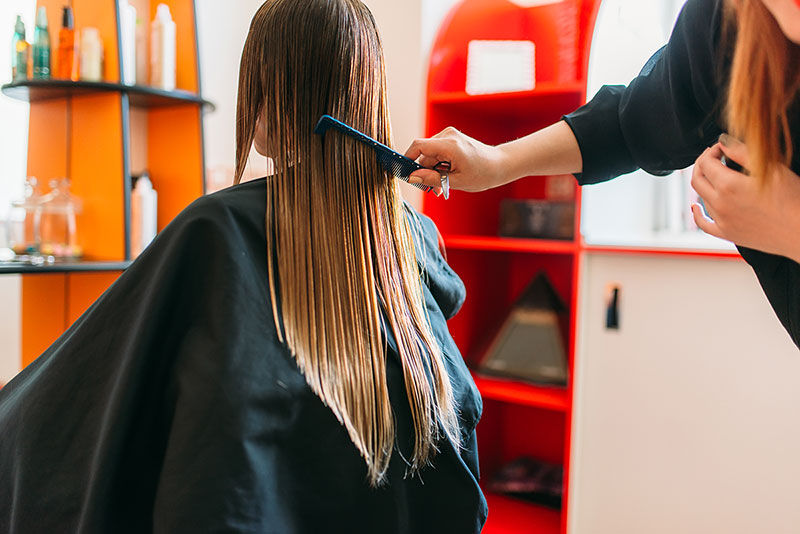 Photo of woman having her hair cut