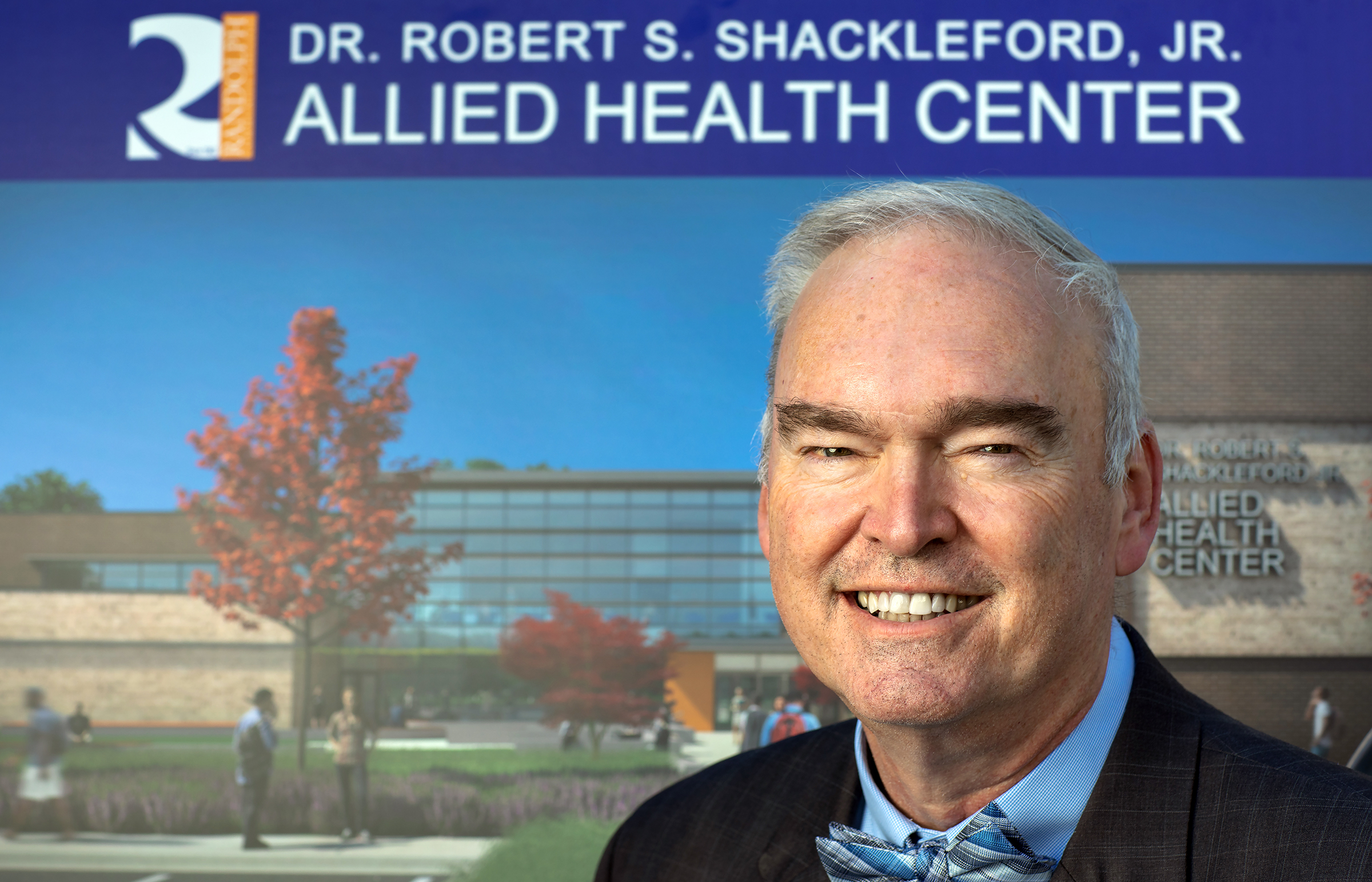 Randolph Community College President Dr. Robert S. Shackleford Jr. stands with an artist's rendering of the new Allied Health Center, which was named after him in a ceremony Thursday.