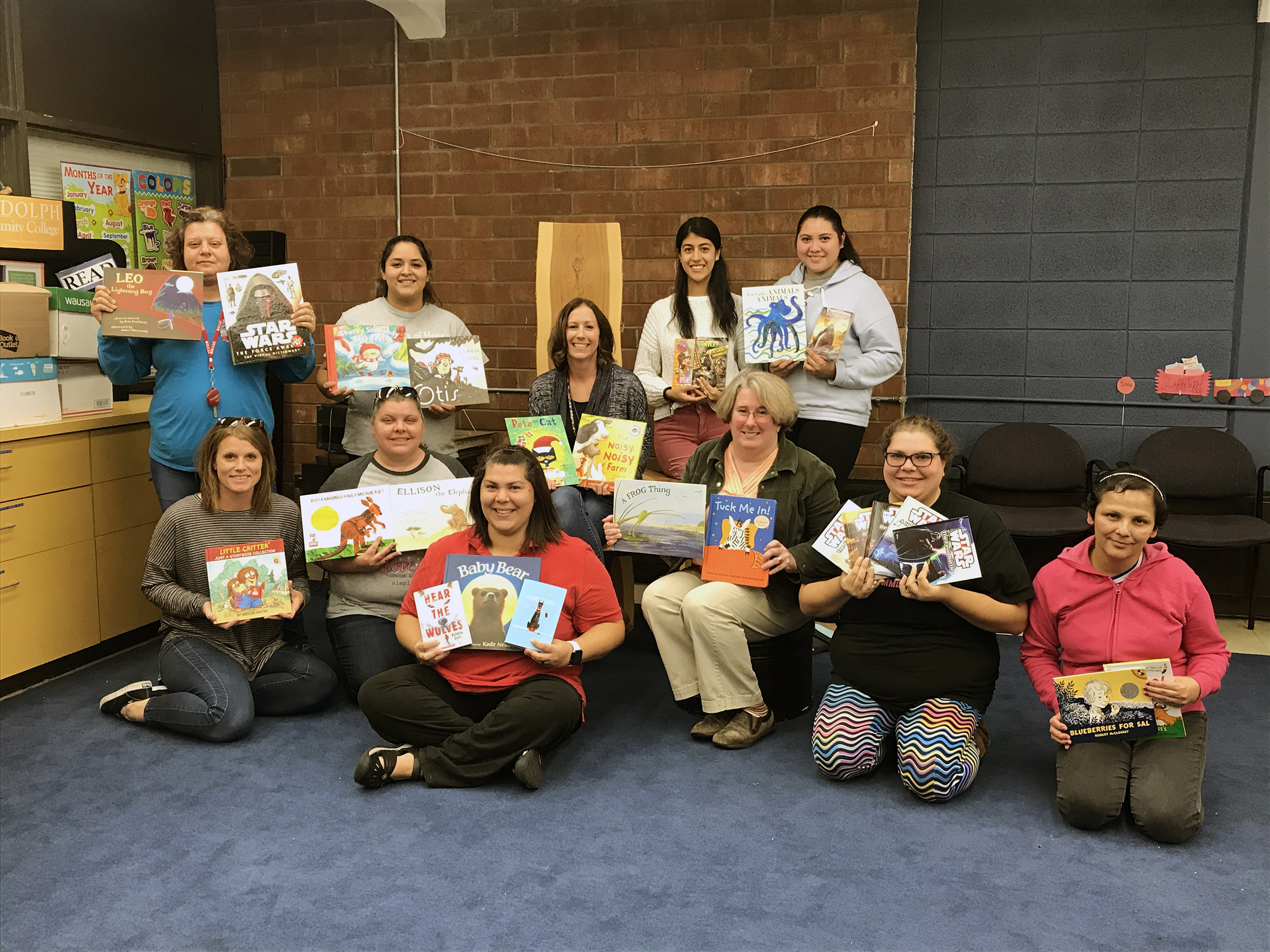 Randolph Community College Early Childhood Education students and faculty display several of the books that were donated in this year’s ECE Department Book Drive Tuesday, Nov. 5.