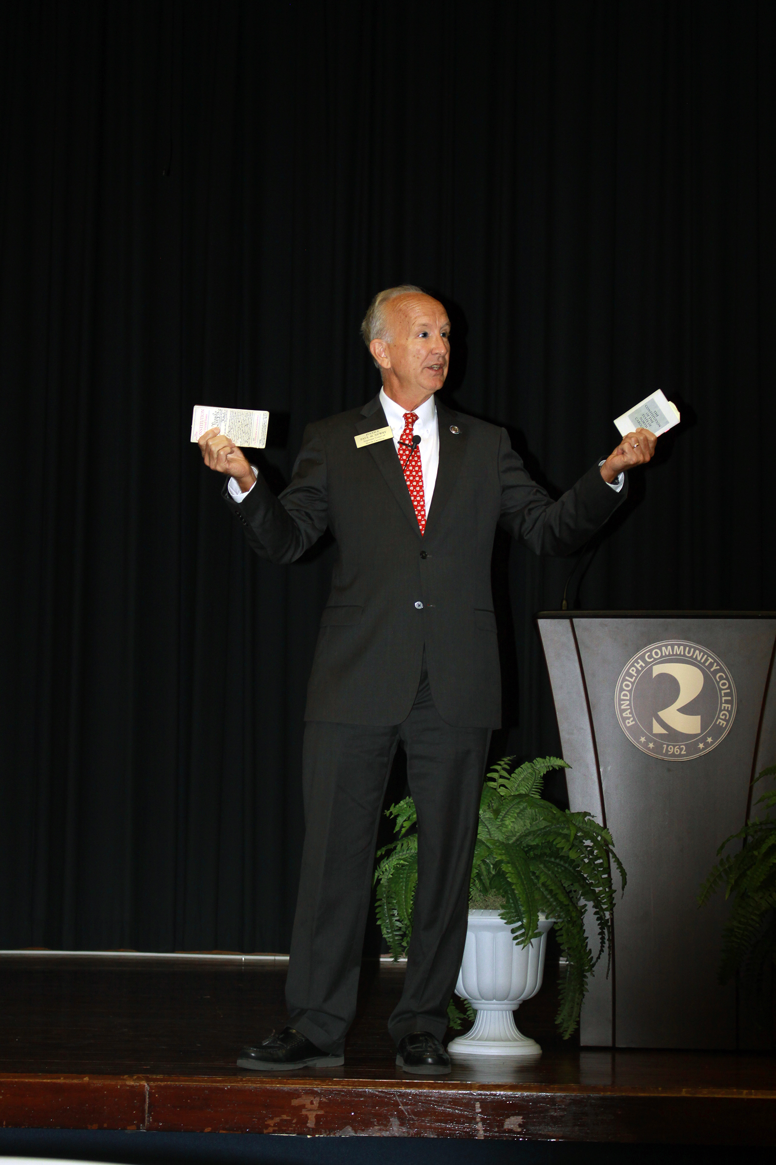 Holding copies of the United States Constitution and the North Carolina Constitution, Paul Newby, the Senior Associate Justice of the Supreme Court of North Carolina, addresses the audience in the R. Alton Cox Learning Resources Center Auditorium on Tuesday, Sept. 17. Newby was on campus for Constitution Day and as part of the celebration of the 200th anniversary of the Supreme Court of North Carolina.