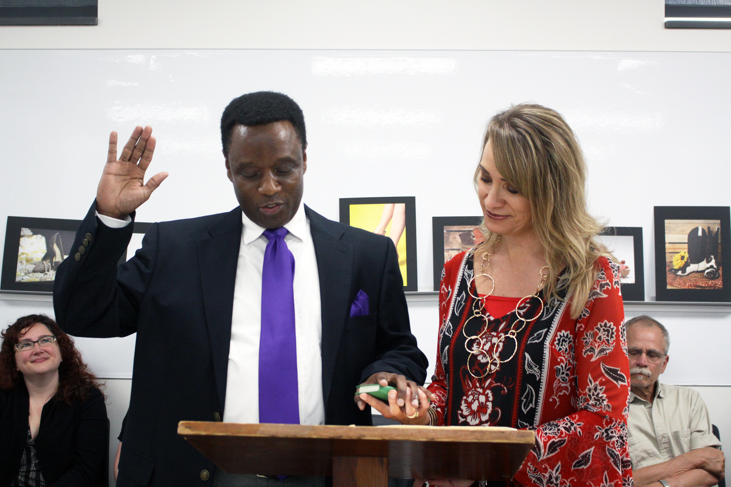 Heather Clouston (right), Executive Assistant to the President and Board of Trustees, administers the oath of office to new RCC Board member Larry Reid at the Board’s meeting July 18.