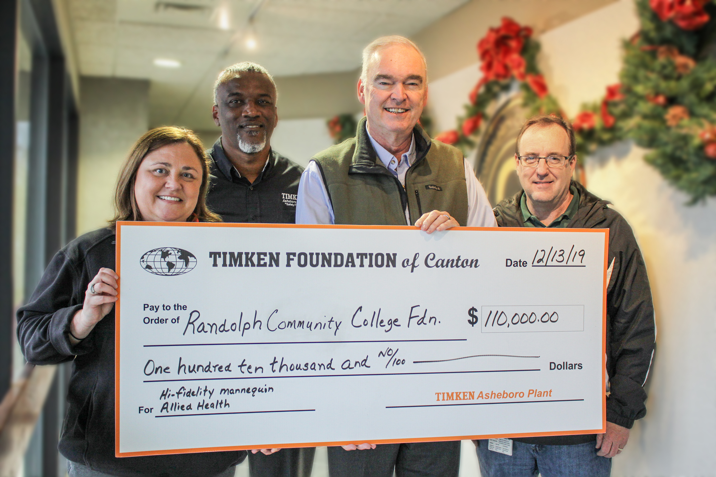 The Timken Foundation awarded a grant of $110,000 to Randolph Community College on Friday, Dec. 13, for the purchase of a hi-fidelity patient simulator mannequin for the College’s Dr. Robert S. Shackleford Jr. Allied Health Center, which will open in the spring of 2020. Pictured, left to right, are Plant Manager Megan Guinee, HR Manager Jody Walker, Shackleford, and Plant Controller Baxter Hammer.