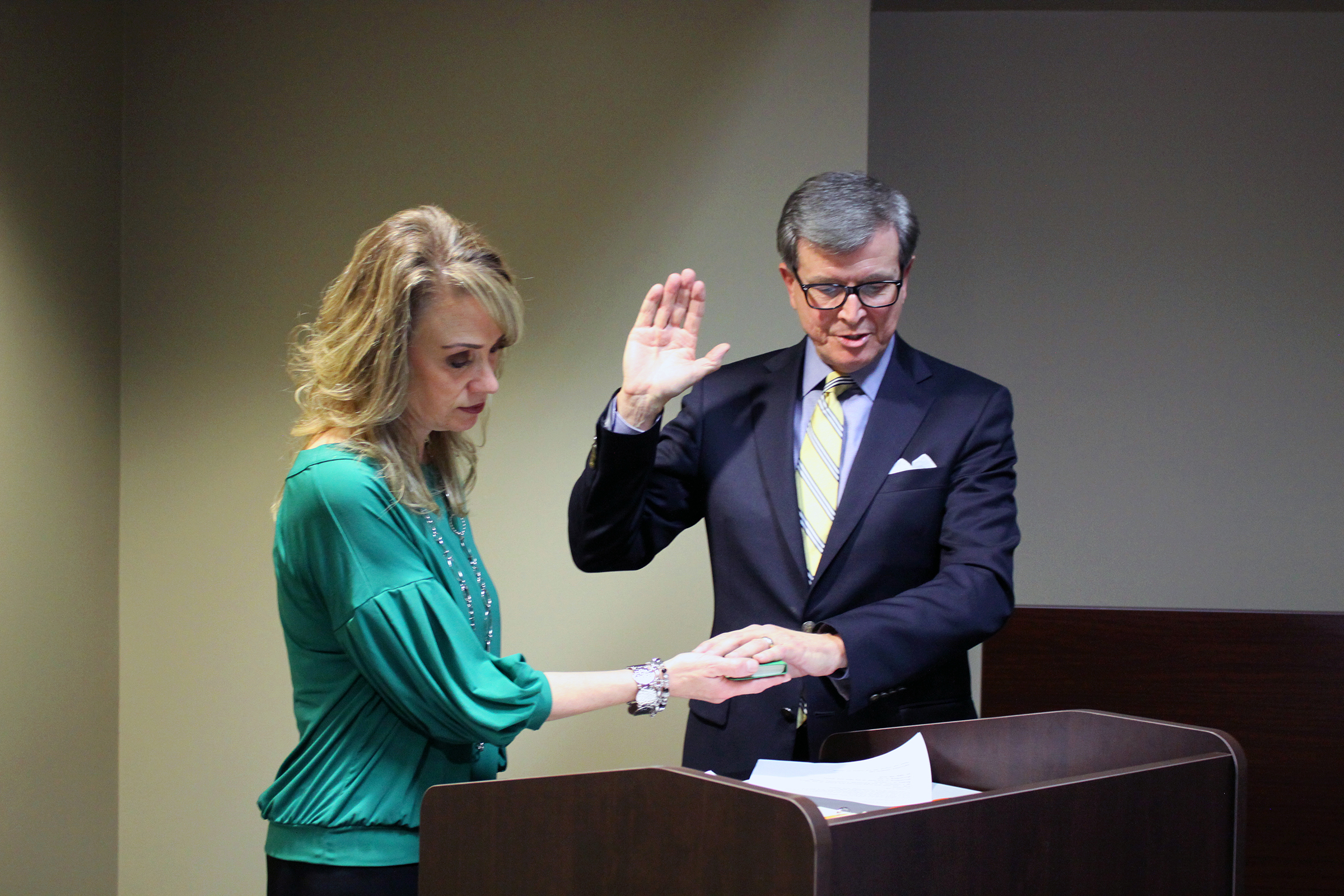 Heather Clouston (left), Executive Assistant to the President and Board of Trustees, administers the oath of office to new Randolph Community College Board member Chris Yow at the Board’s meeting Thursday, Jan. 16, in the Martha Luck Comer Conference Center.