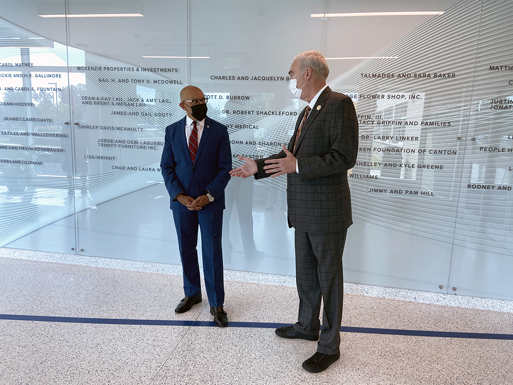 North Carolina Community College System President Thomas Stith III (left) and Randolph Community College President Dr. Robert S. Shackleford Jr. speak by the donor wall of the new Dr. Robert S. Shackleford Allied Health Center during Stith’s visit to the College’s Asheboro Campus on Thursday, Sept. 30.
