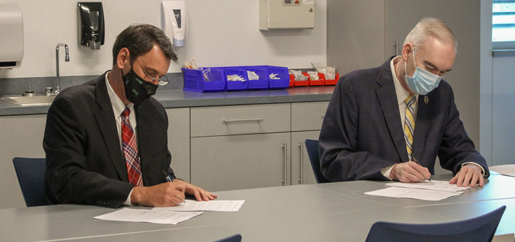 Randolph Community College President Dr. Robert S. Shackleford Jr. (right) and University of Mount Olive President Dr. H. Edward Croom sign two agreements between the schools during a ceremony Thursday, April 15, in the Dr. Robert S. Shackleford Jr. Allied Health Center on the Asheboro Campus