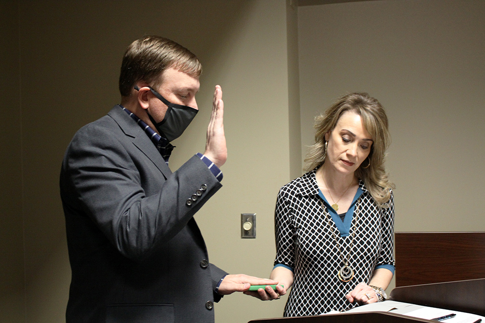 Heather Clouston (right), Executive Assistant to the President and Board of Trustees, administers the oath of office to new RCC Board member Zeb Holden at the Board’s meeting Nov. 18.