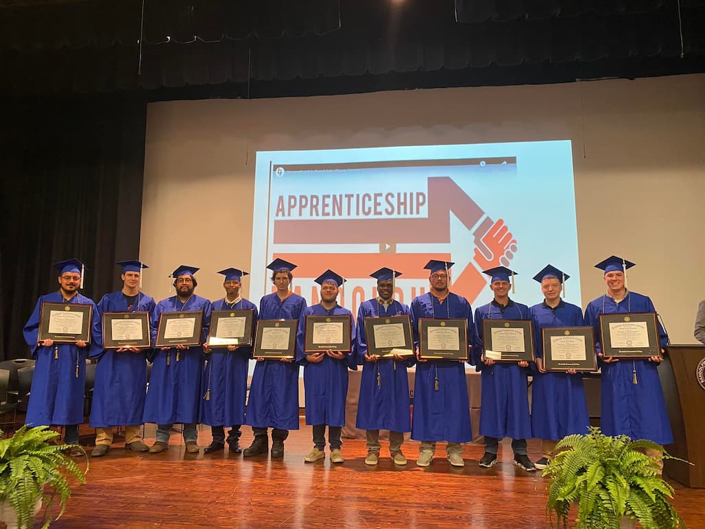 The 12 Apprenticeship Randolph graduates show off their framed associate degrees in Manufacturing Technology on Tuesday, Aug. 9, after a ceremony in the R. Alton Cox Learning Resources Center Auditorium on the Randolph Community College Asheboro Campus. Not pictured is Benjamin Cable.