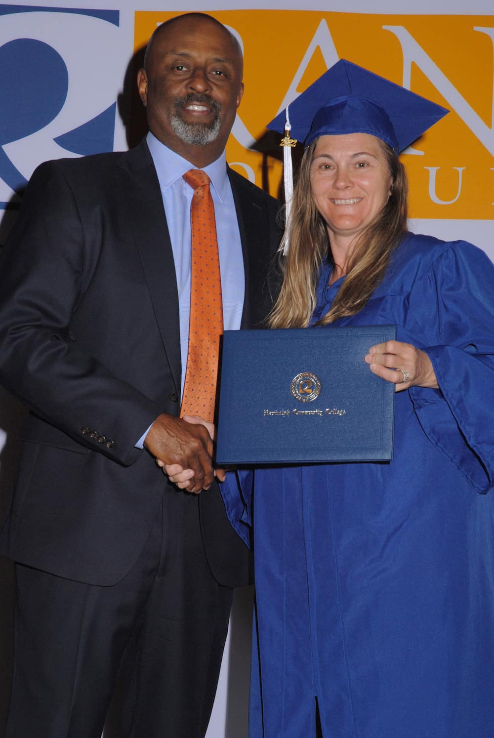 Elbert Lassiter congratulates graduate Angela Brown