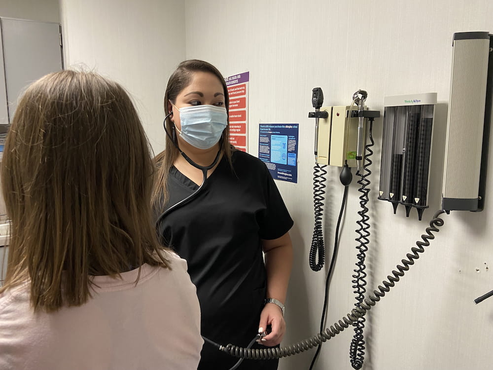 Sanchez checks the blood pressure and heart rate of a ‘patient’