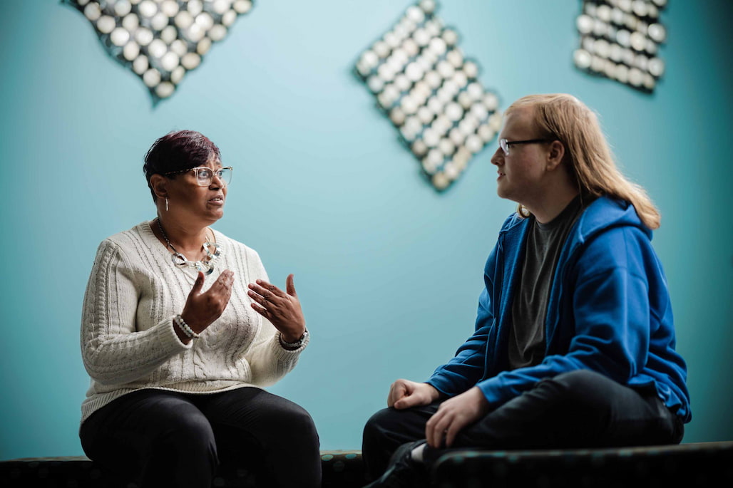 Photo of a woman talking to a student.