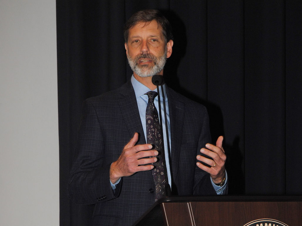 Photo of a man giving a speech.