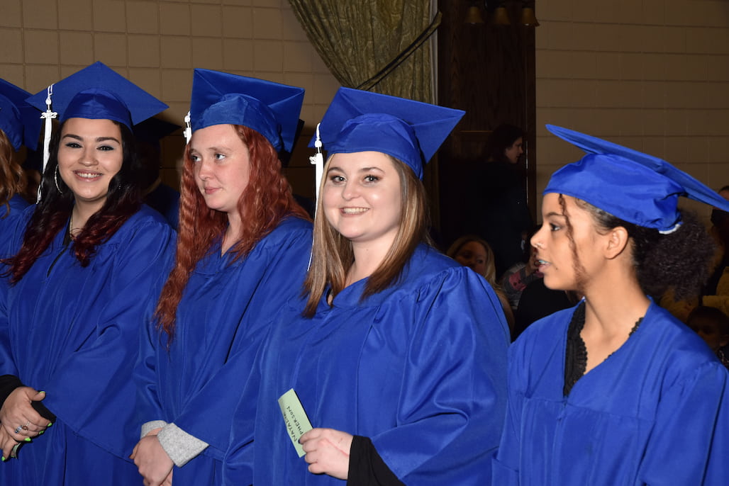 College and Career Readiness (CCR) graduates — left to right — Rachel Moore, Meaghan Miller, Natalie McPherson, and Kiara Lataille prepare to receive their diplomas during the 2022 December CCR Graduation Thursday, Dec. 15, in the R. Alton Cox Learning Resources Center Auditorium on the Asheboro Campus.