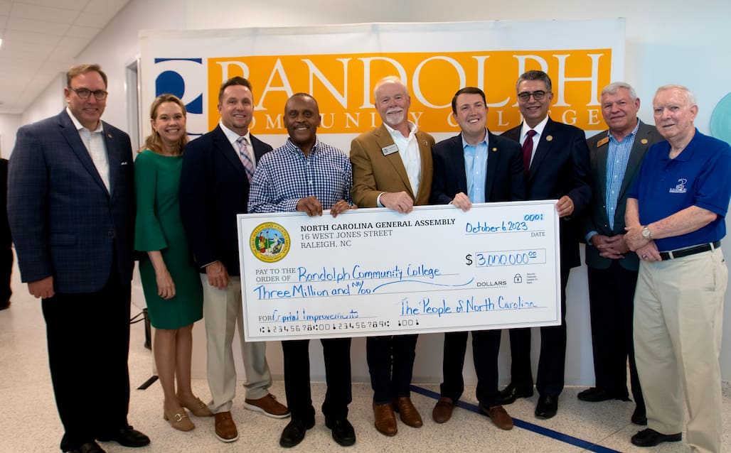 Photo of a group of people holding a large check.