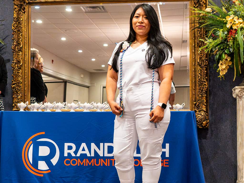 Photo of a Nursing student on stage at the Randolph Community College's program's pinning ceremony.