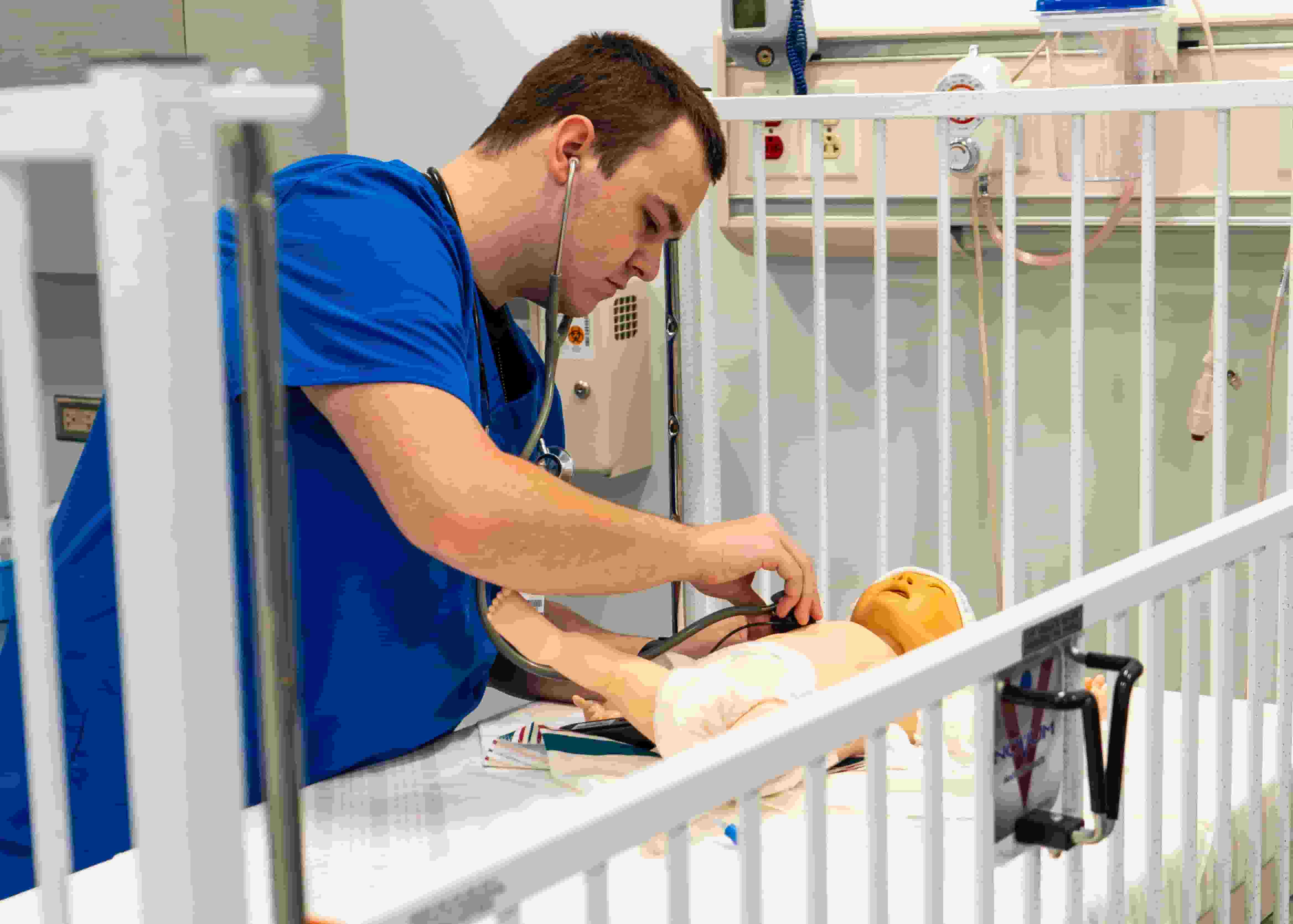 Photo of a Nursing student participating in a clinical simulation focusing on an assessment of a pediatric client at the Allied Health Center at Randolph Community College.