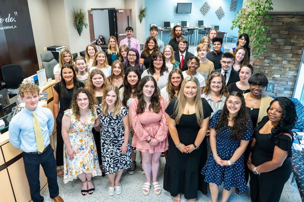 Photo of a large group of people standing in the lobby of the Ann Hoover Welcome Center at Randolph Community College.