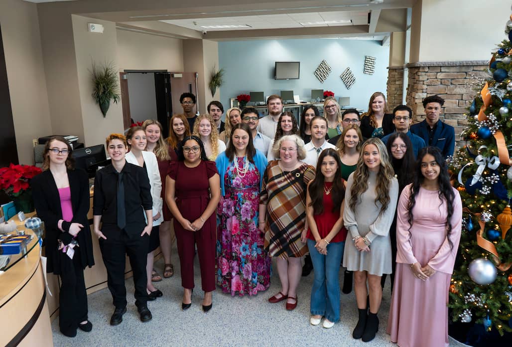 Photo of a group of students standing in the Ann Hoover Welcome Center at Randolph Community College.
