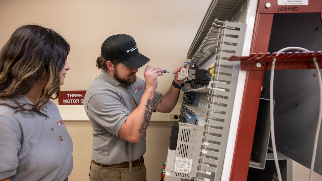 Photo of two apprentices working on circuits.