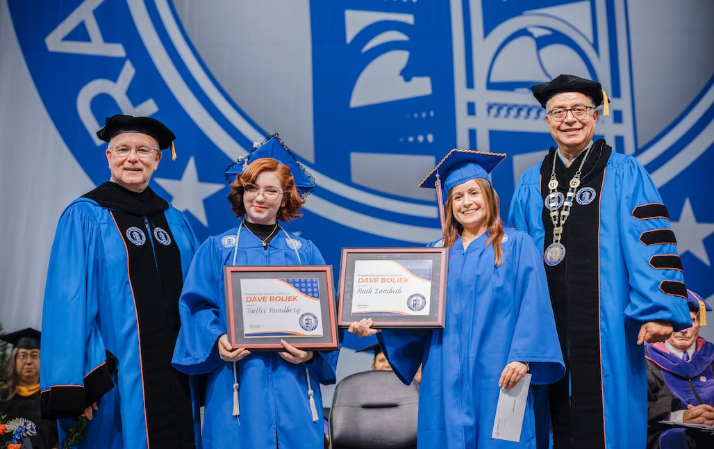 Photo of four people standing on stage at Randolph Community College's 2026 Commencement Ceremony.