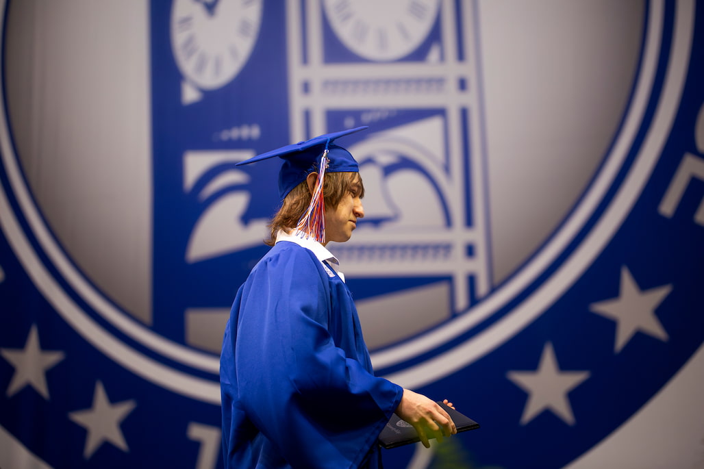 Photo of an RCC graduate crossing the stage at the 2026 Commencement Ceremony.