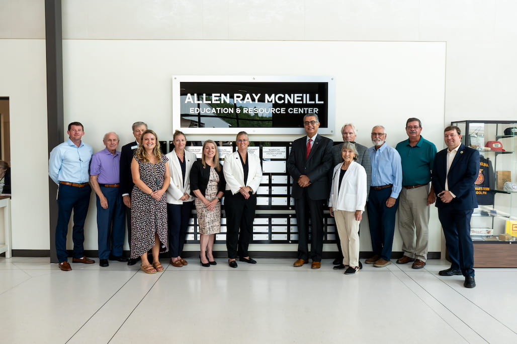 A group of Randolph County and Randolph Community College leaders standing in the foyer of the Allen Ray McNeill Education and Resource Center.