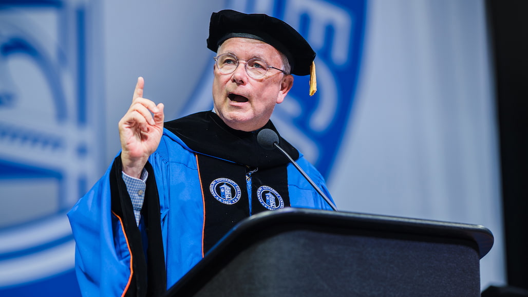Photo of a person giving a commencement address.