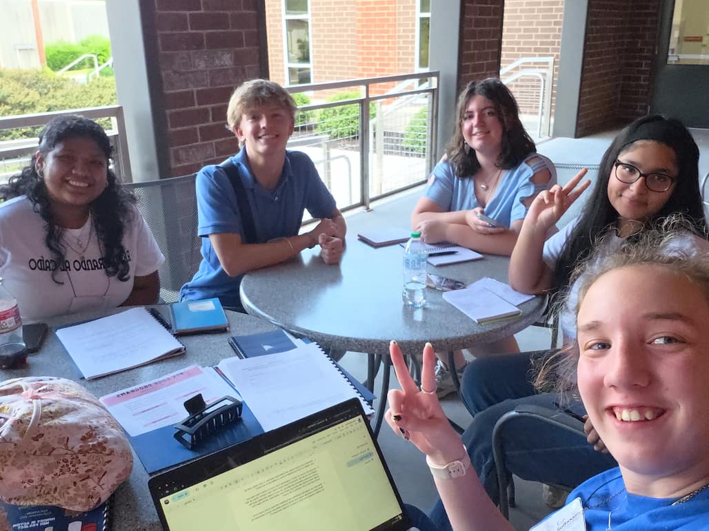 Photo of a group of RCC PTK students sitting around two tables.