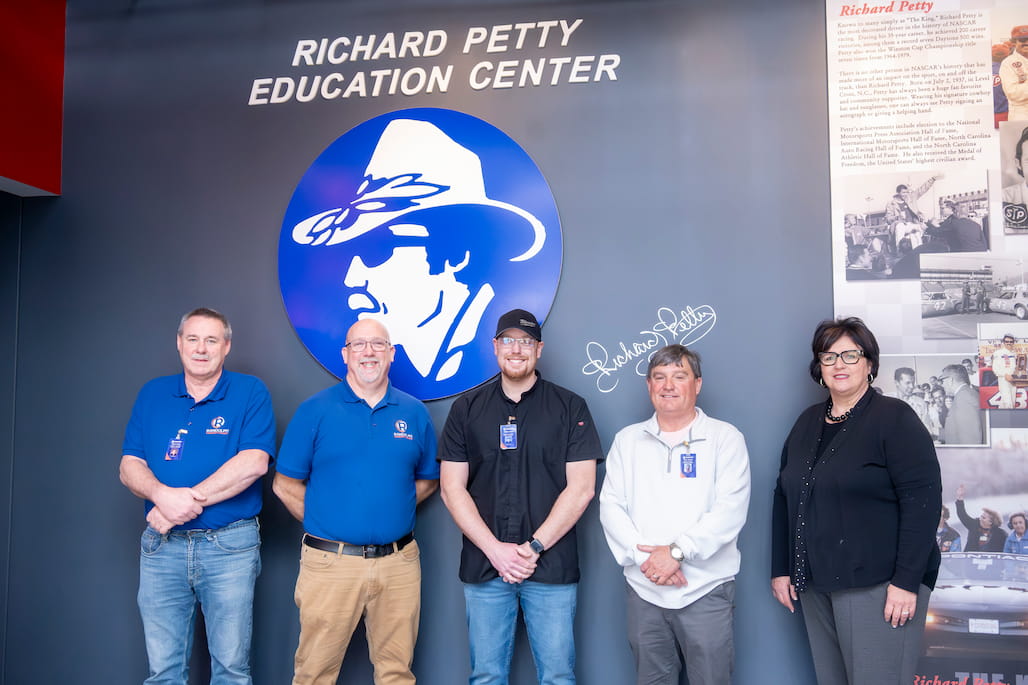 Photo of a group of Randolph Community College employees in the lobby of the Richard Petty Education Center.