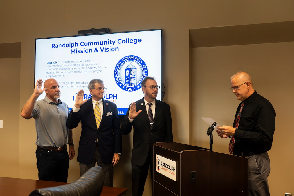 Photo of three members of the Randolph Community College Board of Trustees being sworn in.