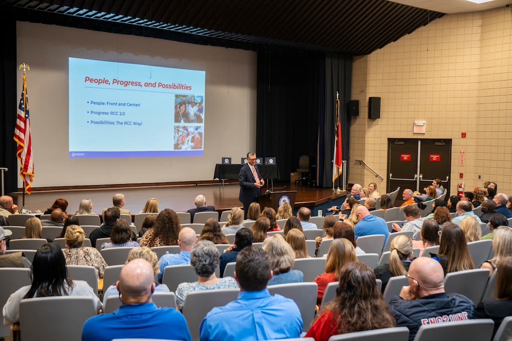 Photo of a person speaking to an audience.