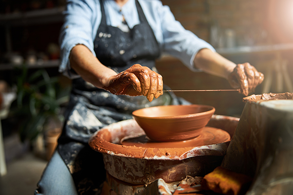 A potter turning a piece