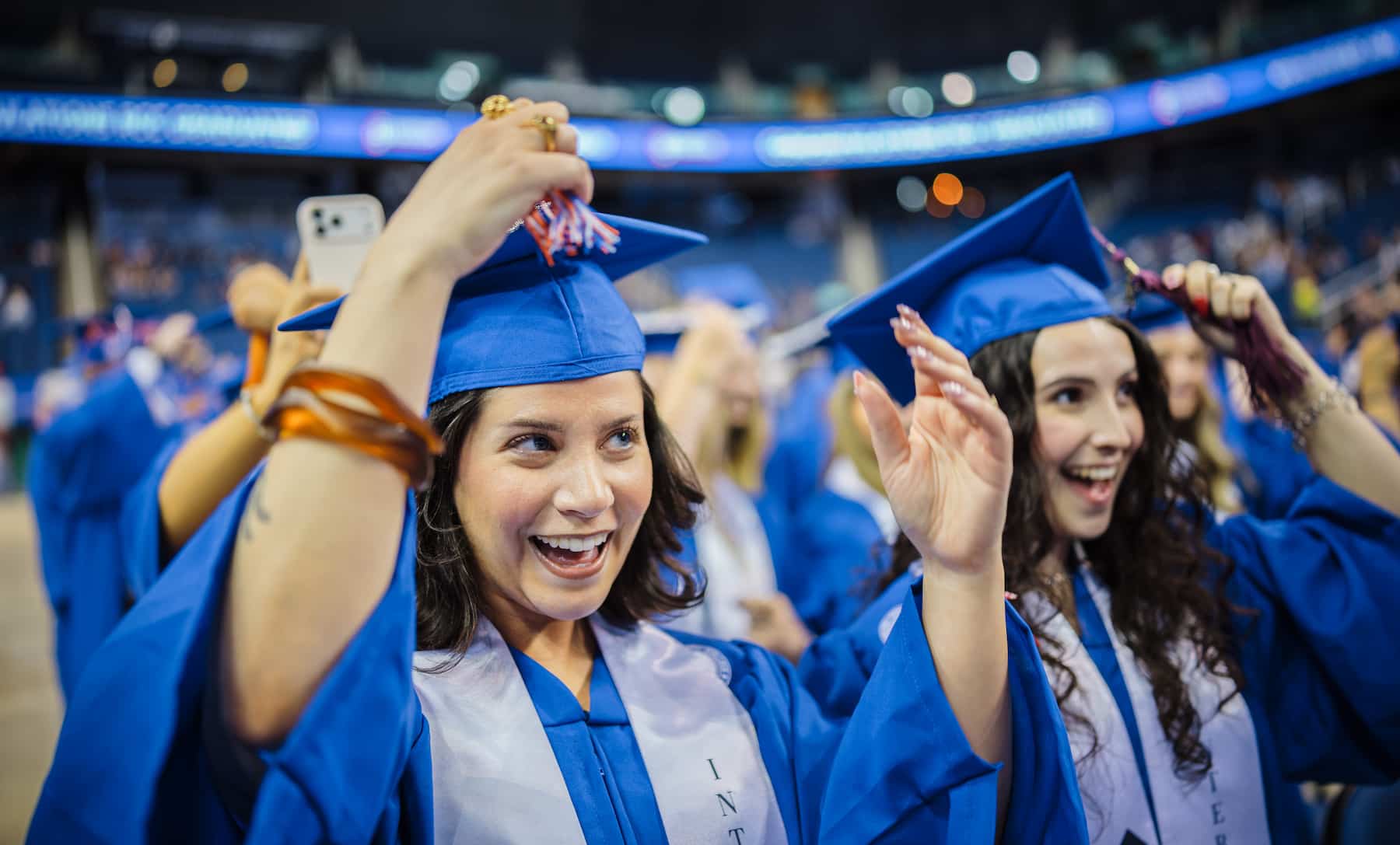 Photo of two RCC graduates turning their tassels.